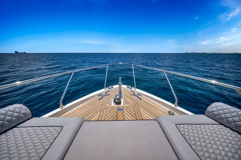  Yacht Photos Pics Ferretti Yachts 670, 2022 model, cruising on open sea with clear blue skies.