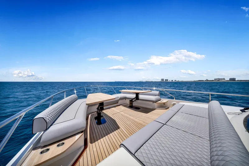  Yacht Photos Pics Luxurious 2022 Ferretti Yachts 670 deck with elegant seating, overlooking serene ocean view.