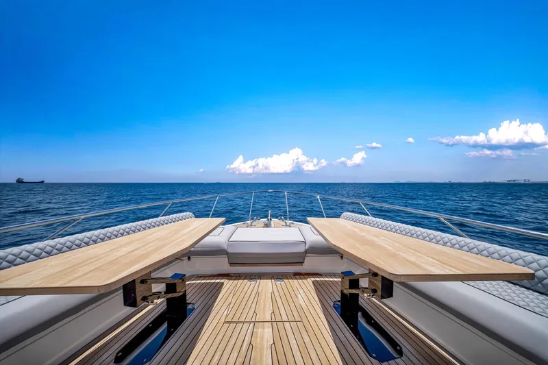  Yacht Photos Pics Luxurious 2022 Ferretti Yachts 670 deck with ocean view and clear blue sky.