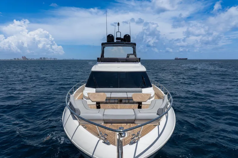  Yacht Photos Pics Luxurious 2022 Ferretti Yachts 670 cruising on open sea under blue skies.
