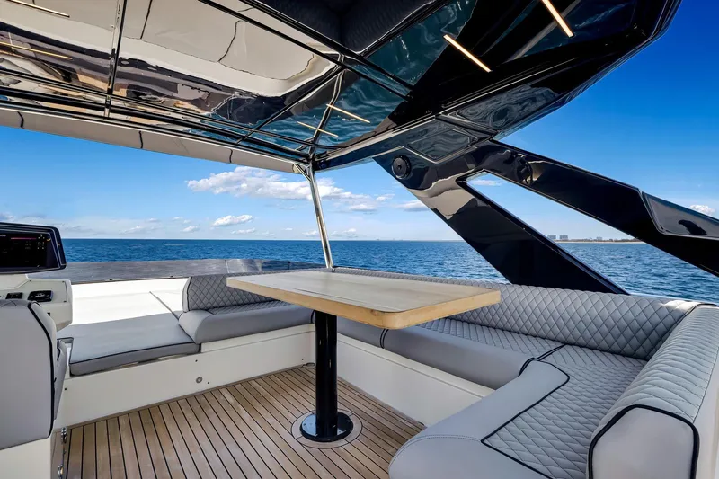  Yacht Photos Pics Luxurious 2022 Ferretti Yachts 670 interior with ocean view, featuring elegant seating and table.