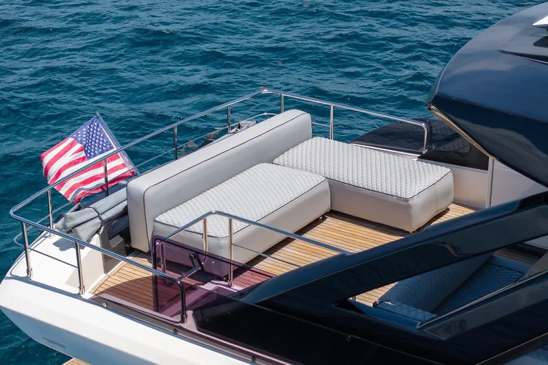  Yacht Photos Pics Luxurious 2022 Ferretti Yachts 670 with elegant deck seating and American flag, cruising on blue waters.