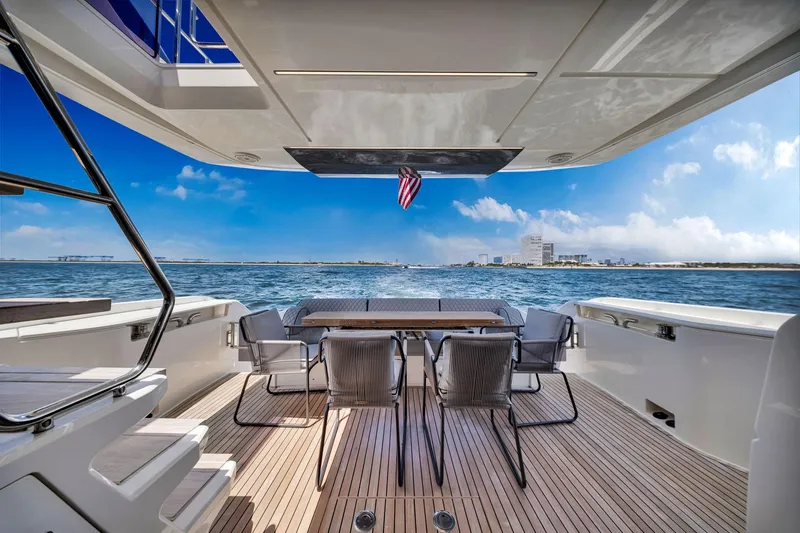  Yacht Photos Pics Luxurious 2022 Ferretti Yachts 670 deck with ocean view and dining area.