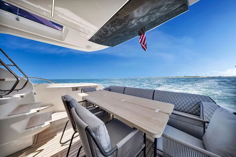  Yacht Photos Pics Luxurious 2022 Ferretti Yachts 670 deck with elegant seating and ocean view.