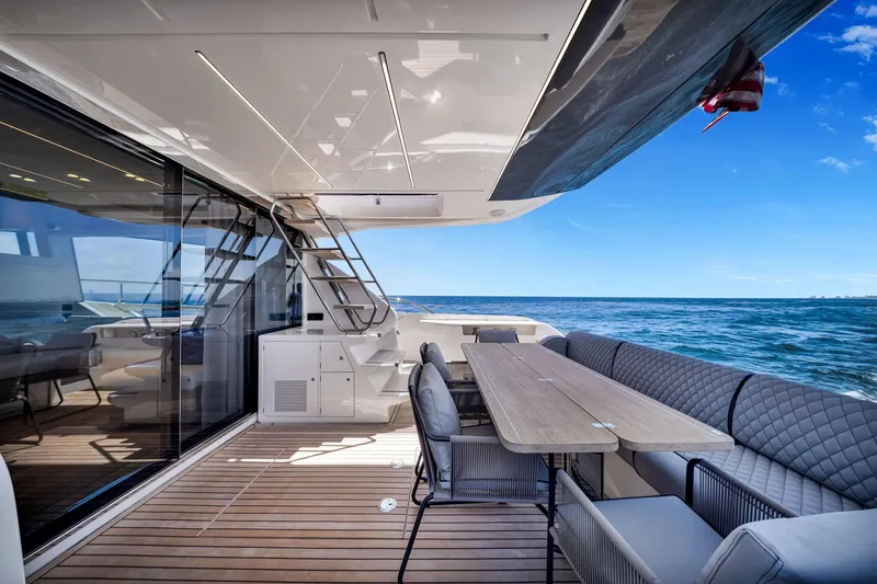 Yacht Photos Pics Luxurious 2022 Ferretti Yachts 670 deck with elegant seating and ocean view.
