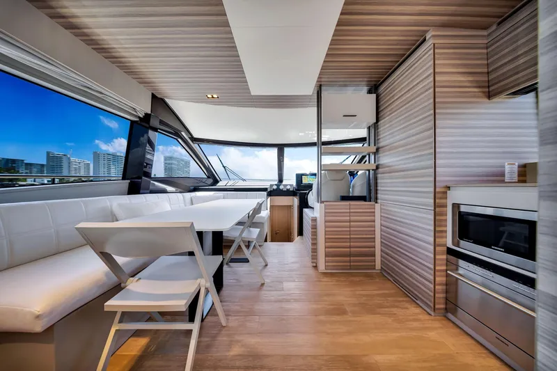  Yacht Photos Pics Luxurious interior of 2022 Ferretti Yachts 670 with modern dining and kitchen area.