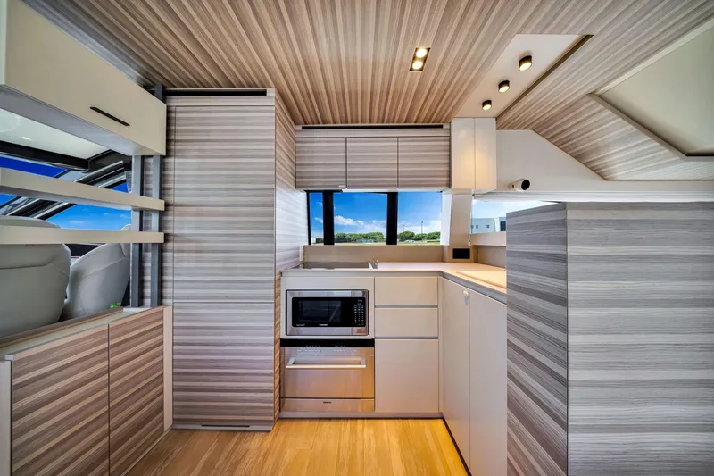  Yacht Photos Pics Modern kitchen interior of 2022 Ferretti Yachts 670, featuring sleek cabinetry and appliances.