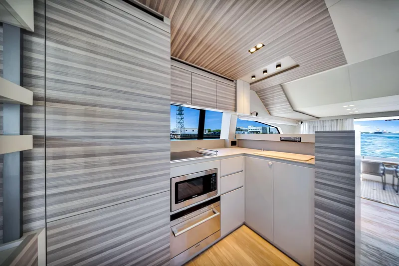  Yacht Photos Pics Modern kitchen interior of 2022 Ferretti Yachts 670, featuring sleek cabinetry and ocean view.