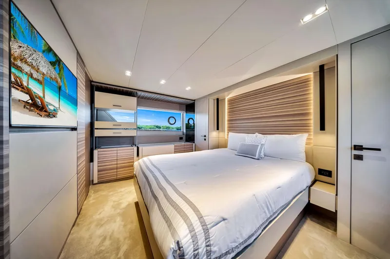  Yacht Photos Pics Luxurious bedroom interior of 2022 Ferretti Yachts 670 with modern design and scenic artwork.