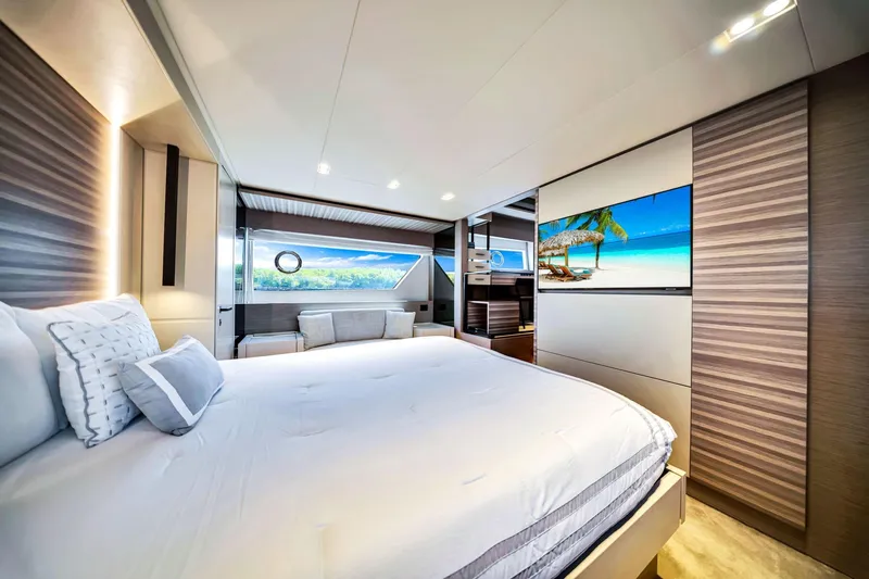 Yacht Photos Pics Luxurious bedroom interior of 2022 Ferretti Yachts 670 with modern design and scenic view.