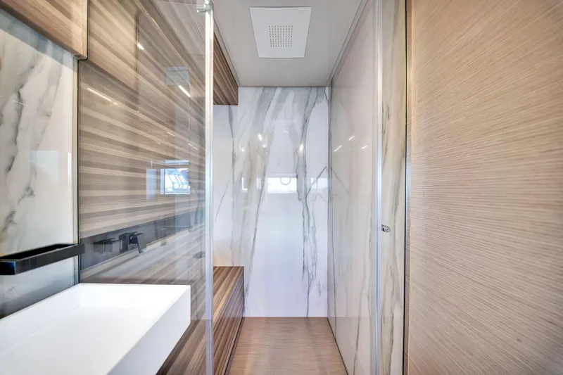  Yacht Photos Pics Luxurious bathroom interior of 2022 Ferretti Yachts 670 with marble and wood finishes.