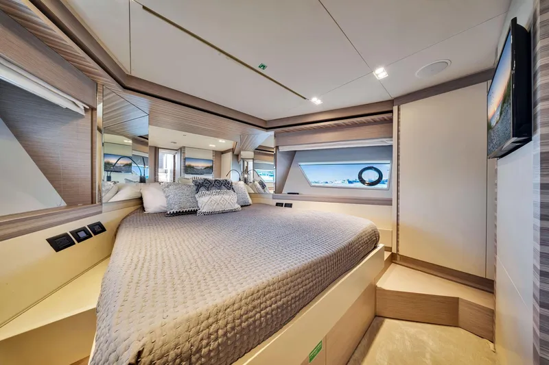  Yacht Photos Pics Luxurious bedroom interior of 2022 Ferretti Yachts 670 with modern design and elegant furnishings.