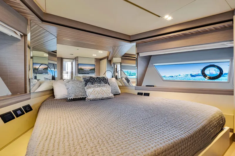  Yacht Photos Pics Luxurious bedroom interior of 2022 Ferretti Yachts 670 with modern design and ocean view.