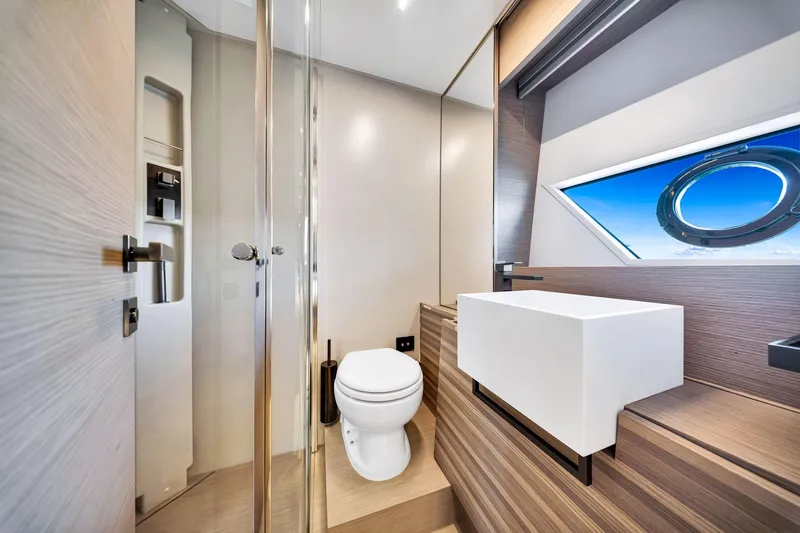  Yacht Photos Pics Luxurious bathroom interior of 2022 Ferretti Yachts 670 with modern fixtures and ocean view.