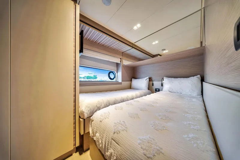  Yacht Photos Pics Luxurious twin bedroom in 2022 Ferretti Yachts 670, featuring elegant decor and natural light.