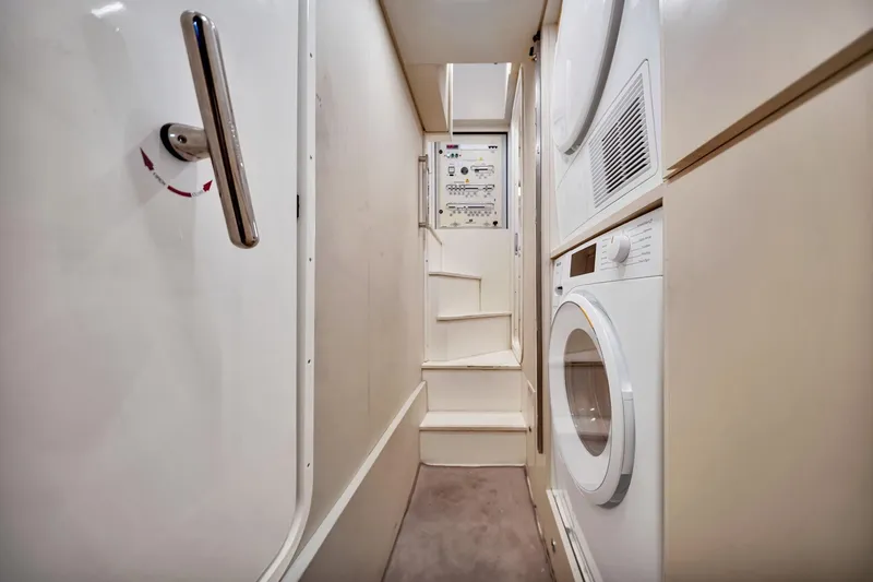  Yacht Photos Pics Laundry area inside 2022 Ferretti Yachts 670, featuring washer and dryer units.