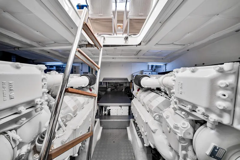  Yacht Photos Pics Engine room of 2022 Ferretti Yachts 670, featuring dual engines and ladder access.