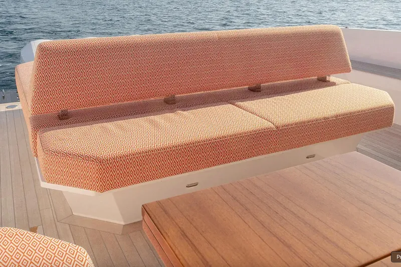  Yacht Photos Pics Luxurious seating on 2024 Delta Powerboats 60 Open, featuring patterned upholstery and wooden deck.