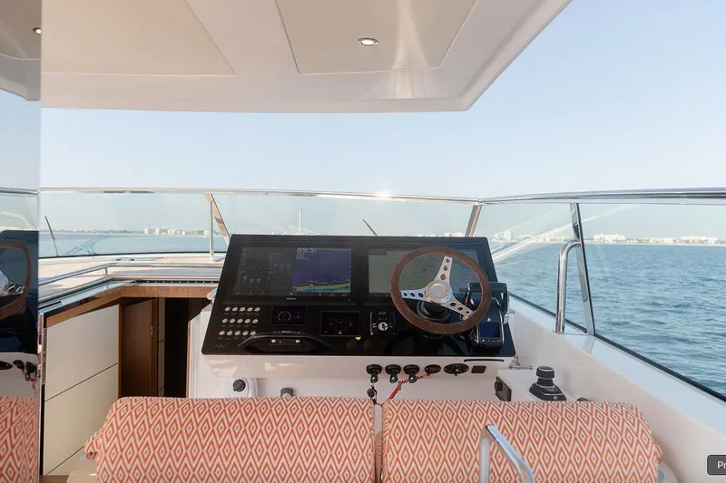  Yacht Photos Pics Cockpit of 2024 Delta Powerboats 60 Open, featuring modern navigation controls and ocean view.