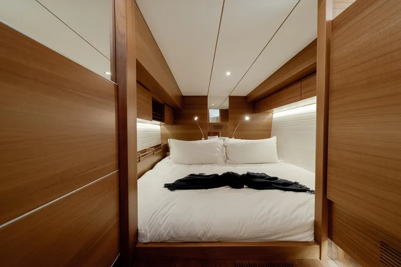  Yacht Photos Pics Luxurious cabin interior of 2024 Delta Powerboats 60 Open, featuring elegant wood paneling.