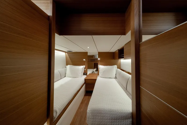  Yacht Photos Pics Luxurious cabin interior of 2024 Delta Powerboats 60 Open, featuring twin beds and elegant wood finish.