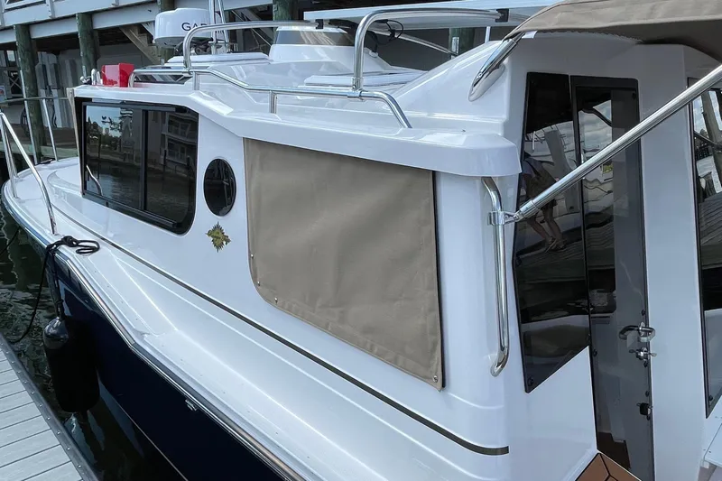  Yacht Photos Pics 2025 Ranger Tugs R-27 Seakeeper Ride docked, showcasing sleek design and modern features.