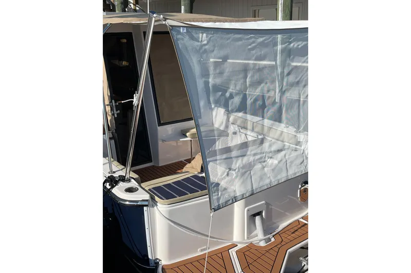  Yacht Photos Pics 2025 Ranger Tugs R-27 Seakeeper Ride with deck canopy and seating area.