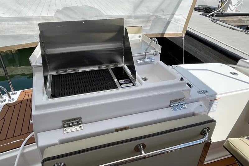  Yacht Photos Pics Outdoor grill and sink on 2025 Ranger Tugs R-27 Seakeeper Ride boat deck.