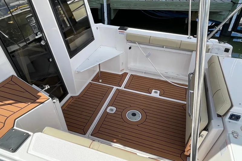  Yacht Photos Pics 2025 Ranger Tugs R-27 Seakeeper Ride boat interior with teak flooring and seating.