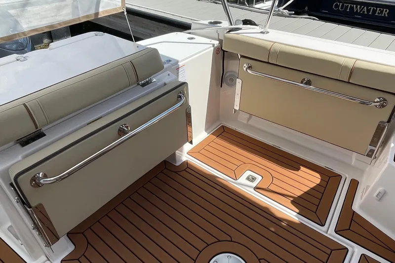  Yacht Photos Pics 2025 Ranger Tugs R-27 Seakeeper Ride interior with cushioned seating and teak-style flooring.