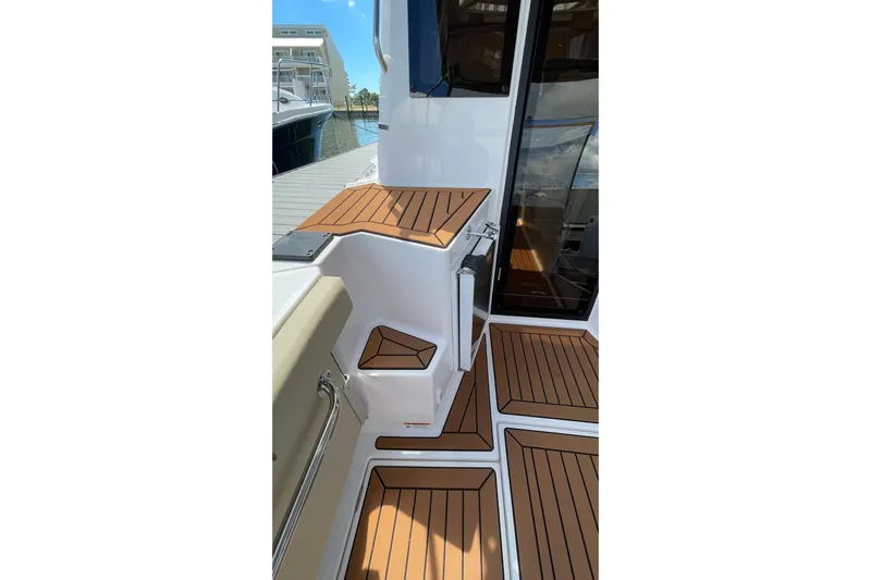  Yacht Photos Pics 2025 Ranger Tugs R-27 Seakeeper Ride boat deck with wood finish, docked at marina.