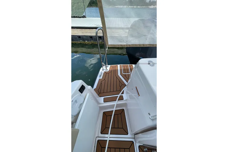  Yacht Photos Pics 2025 Ranger Tugs R-27 Seakeeper Ride boat deck with wood-patterned flooring.