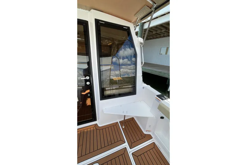  Yacht Photos Pics 2025 Ranger Tugs R-27 Seakeeper Ride, featuring sleek deck design and modern window detailing.