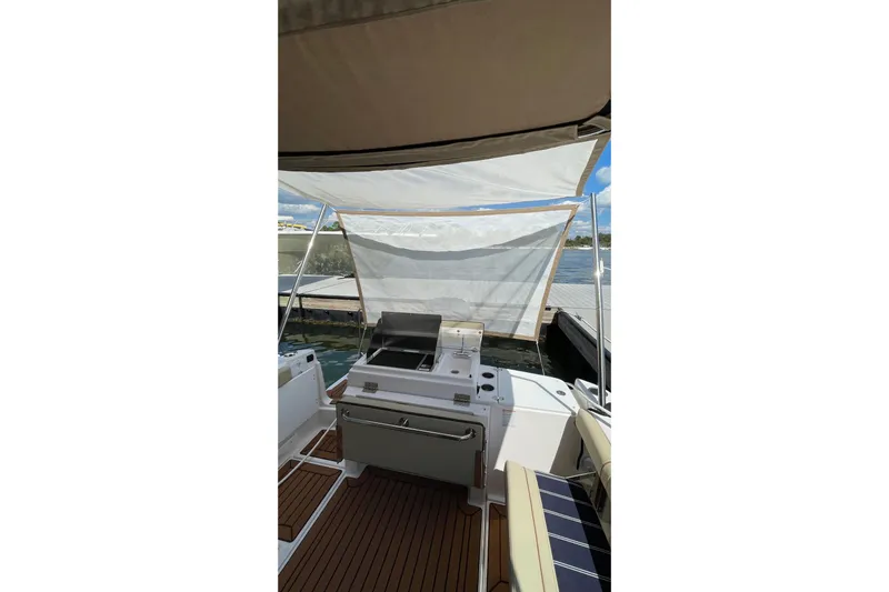  Yacht Photos Pics 2025 Ranger Tugs R-27 Seakeeper Ride with outdoor kitchen and canopy on deck.