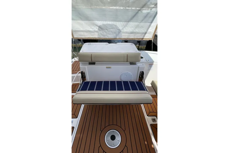  Yacht Photos Pics 2025 Ranger Tugs R-27 Seakeeper Ride interior with cushioned seating and teak flooring.