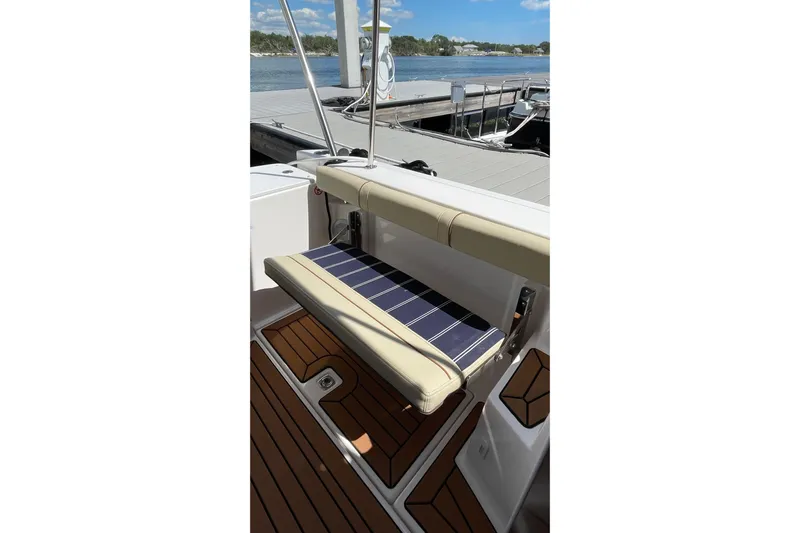  Yacht Photos Pics 2025 Ranger Tugs R-27 Seakeeper Ride boat seat with striped cushion, dockside view.
