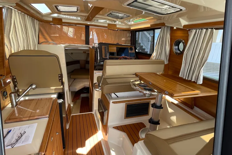  Yacht Photos Pics 2025 Ranger Tugs R-27 Seakeeper Ride interior with wood accents and seating area.