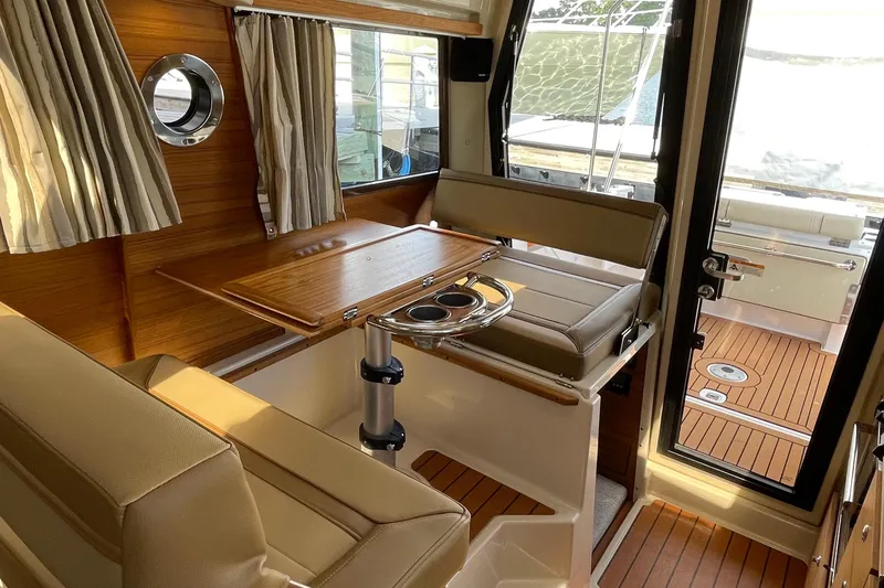  Yacht Photos Pics Interior of 2025 Ranger Tugs R-27 Seakeeper Ride, featuring elegant seating and wooden accents.