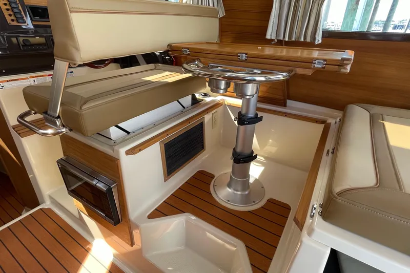  Yacht Photos Pics Interior of 2025 Ranger Tugs R-27 Seakeeper Ride with seating and wooden accents.