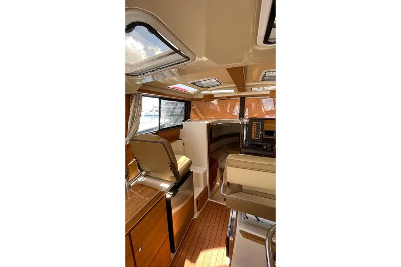  Yacht Photos Pics Interior of 2025 Ranger Tugs R-27 Seakeeper Ride, featuring elegant wood finishes and modern design.