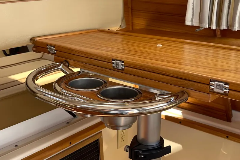  Yacht Photos Pics 2025 Ranger Tugs R-27 Seakeeper Ride interior with wooden table and stainless steel cup holders.