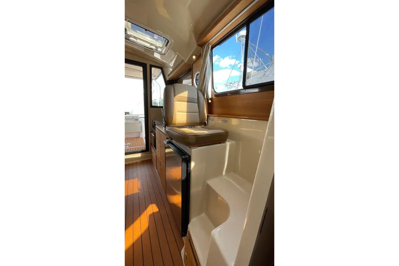  Yacht Photos Pics Interior of 2025 Ranger Tugs R-27 Seakeeper Ride with wood flooring and seating.