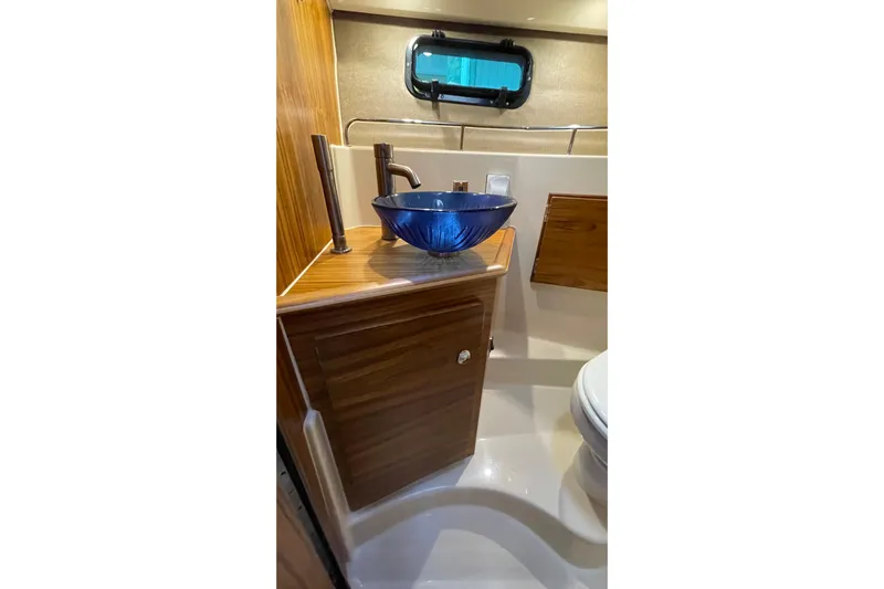  Yacht Photos Pics Luxurious bathroom in 2025 Ranger Tugs R-27 Seakeeper Ride with blue glass sink.
