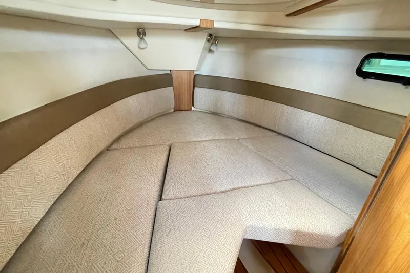  Yacht Photos Pics 2025 Ranger Tugs R-27 Seakeeper Ride interior cabin with cushioned seating.