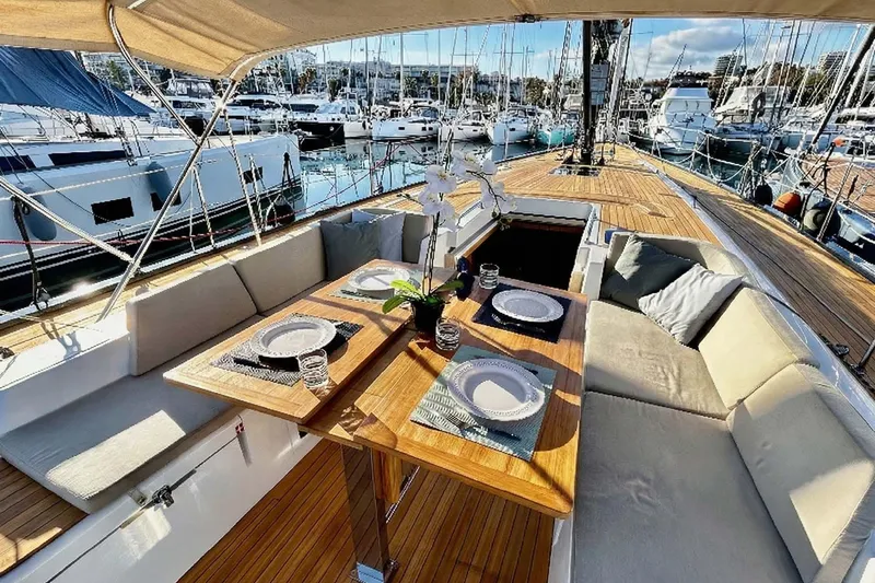 Nemo Yacht Photos Pics Luxurious 2022 Solaris 55 yacht with elegant outdoor dining area in marina setting.