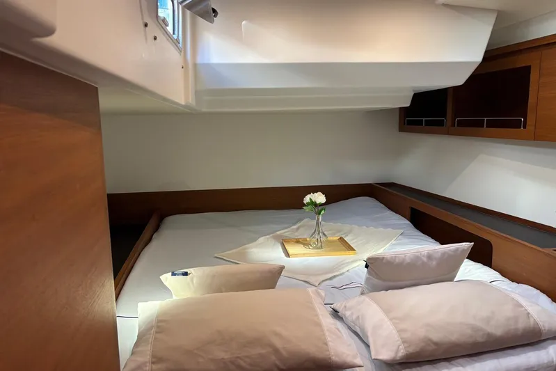 Nemo Yacht Photos Pics Luxurious cabin interior of 2022 Solaris 55 yacht with cozy bedding and elegant decor.