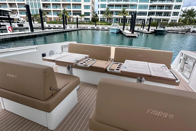 M2o Yacht Photos Pics Luxurious seating area on 2024 Fjord 53 XL yacht, docked at a marina.