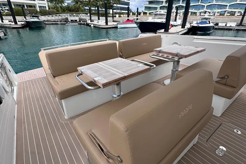M2o Yacht Photos Pics Luxurious seating area on a 2024 Fjord 53 XL yacht, docked at a marina.