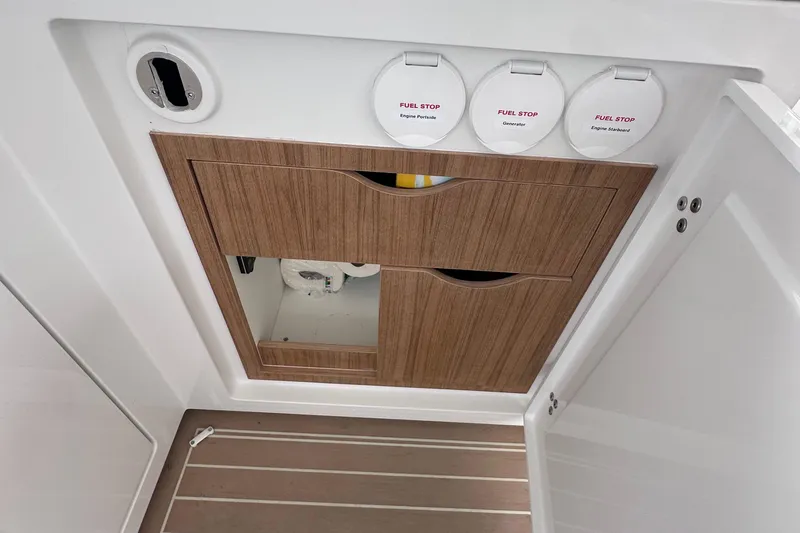 M2o Yacht Photos Pics 2024 Fjord 53 XL yacht fuel stop panel with wooden cabinet and white interior.