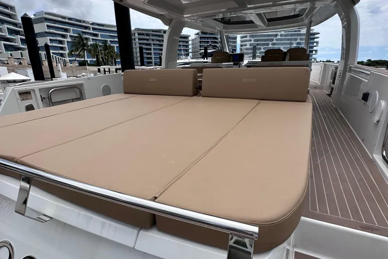 M2o Yacht Photos Pics 2024 Fjord 53 XL yacht with spacious sunbed and modern design in marina setting.